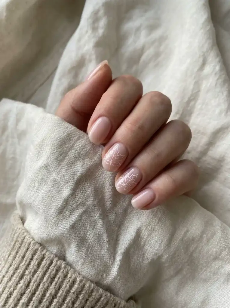 10. Delicate White Leaf Nails